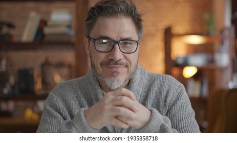 Happy Bearded Older Man At Home Wearing Glasses Looking At Camera, Smiling. Portrait Of Mature Age, Middle Age, Mid Adult Man In 50s.