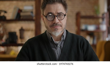 Happy Bearded Older Man At Home Wearing Glasses Looking At Camera, Smiling. Portrait Of Mature Age, Middle Age, Mid Adult Man In 50s.