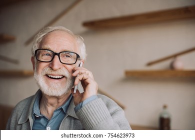 happy bearded senior man talking by phone