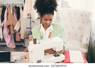 Happy beautiful African American woman fashion designer clothes working with sewing in own dressmaking studio or boutique	 - Powered by Shutterstock