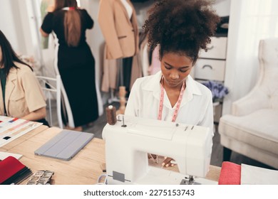 Happy beautiful African American woman fashion designer clothes working with sewing in own dressmaking studio or boutique	 - Powered by Shutterstock