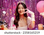 Happy beautiful Asian girl in princess dress showing birthday cake. Birthday princess photography theme is popular in Asia.