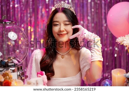 Happy beautiful Asian girl in princess dress showing birthday cake. Birthday princess photography theme is popular in Asia.