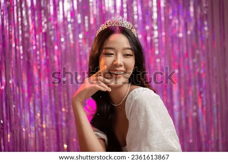 Happy beautiful Asian girl in princess dress showing birthday cake. Birthday princess photography theme is popular in Asia.