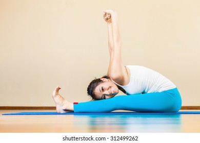 Happy And Beautiful Asian Woman Doing Exercise Of Yoga Indoor At Home. She Looking At Camera And Smiling. Concept Of A Healthy Lifestyle, Sport And The Right Attitude To Life