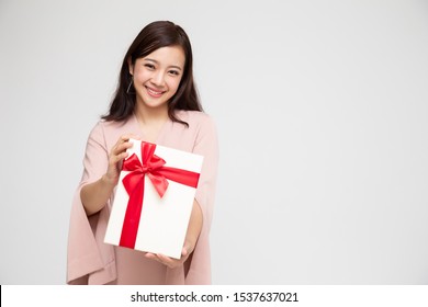 Happy beautiful asian woman smile with gift box isolated on white background. Teenage girls in love, Receiving gifts from lovers. New Year, Christmas and Valentines Day concept - Shutterstock ID 1537637021