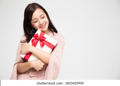 Happy beautiful asian woman smile and hugging gift box isolated on white background. Teenage girls in love, Receiving gifts from lovers. New Year, Christmas and Valentines Day concept - Shutterstock ID 1815429959