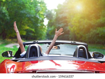 Happy Beautiful Blond Young Woman Driving A Sports Car