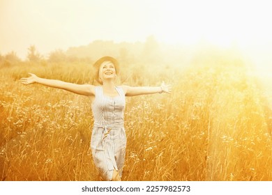 Happy beautiful blonde woman dancing in wild  field.  - Powered by Shutterstock