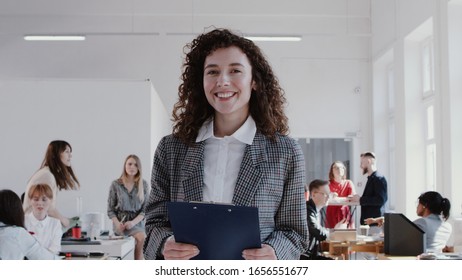 Happy Beautiful Caucasian Business Woman With Curly Hair Walking Along Office Smiling At Camera Slow Motion RED EPIC.