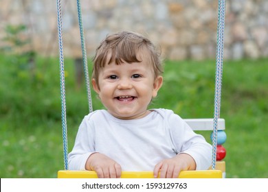 Happy beautiful child on swing
