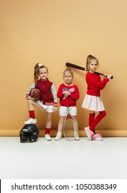 Happy And Beautiful Children Showing Different Sport. Studio Fashion Concept. American Football, Baseball And Tennis Players. Children's Fashion Show. Sport Style. Teen And Kids Fashion Concept.