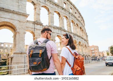 happy beautiful couple in front of coliseum in Pula Croatia. travel concept