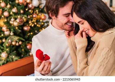 Happy beautiful couple of lovers celebrating Christmas at home - Winter holiday season, celebration of xmas eve in a decorated apartment - Powered by Shutterstock