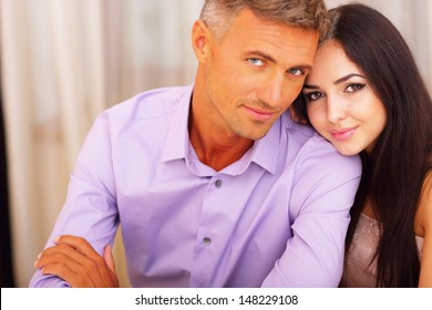 Happy Beautiful Couple Sitting At The Table At Home