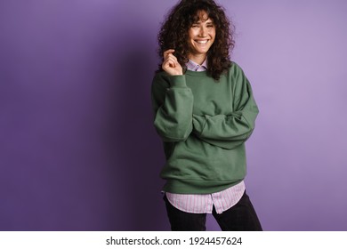 Happy Beautiful Curly Girl Smiling And Looking At Camera Isolated Over Purple Background