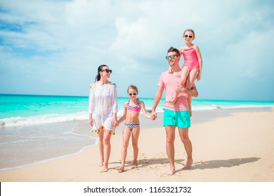 Happy Beautiful Family On White Beach