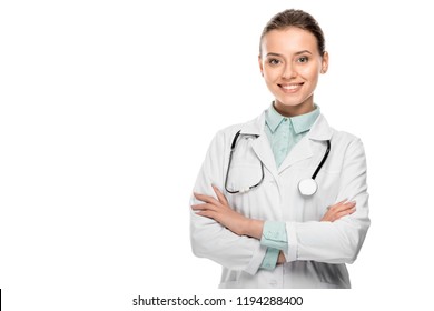 happy beautiful female doctor in medical coat standing with crossed arms isolated on white 