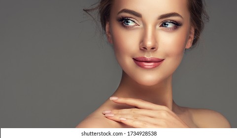 Happy beautiful girl holding her cheeks  a laugh   looking to the side.Young woman with clean fresh skin. Famele beauty face care and treatment. Expressive facial expressions  .Cosmetology  & spa  - Shutterstock ID 1734928538