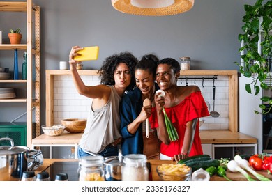 Happy beautiful hispanic south american and black women meeting indoors and having fun - Black adult females best friends spending time together, concepts about domestic life, leisure, friendship  - Powered by Shutterstock