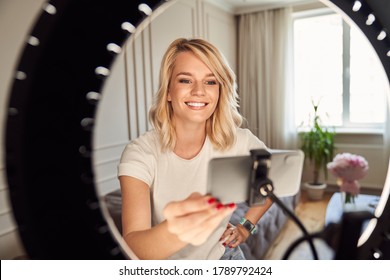 Happy Beautiful Lady Setting Her Ring Light And Getting Ready For Recording Herself On A Modern Smartphone