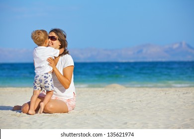 Happy Beautiful Mother And Son Enjoying Beach Time