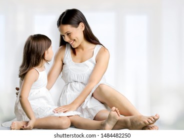 Happy Beautiful Mother's And Child On Window Background