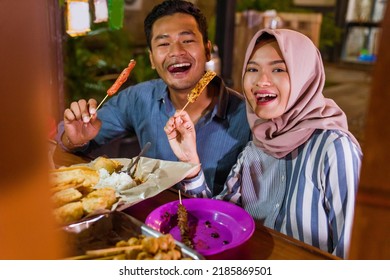 Happy Beautiful Muslim Couple Smiling At Camera Having Dinner Out At Traditional Food Stall In The Evening During Ramadan