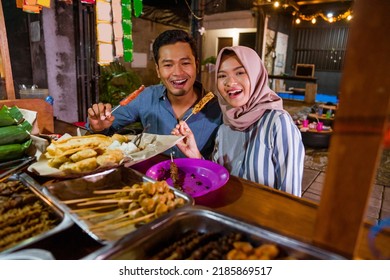 Happy Beautiful Muslim Couple Smiling At Camera Having Dinner Out At Traditional Food Stall In The Evening During Ramadan