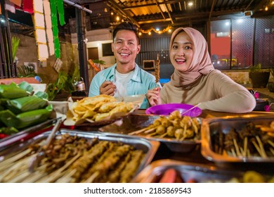 Happy Beautiful Muslim Couple Smiling At Camera Having Dinner Out At Traditional Food Stall In The Evening During Ramadan