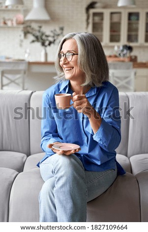 Similar – Image, Stock Photo woman having a cup of tea at home during breakfast. Cute golden retriever dog besides. Healthy breakfast with fruits and sweets. lifestyle indoors