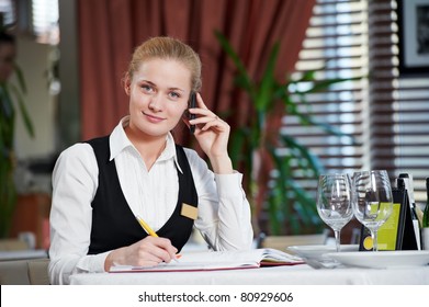 Happy Beautiful Restaurant Manager Woman Administrator At Work Place With Phone