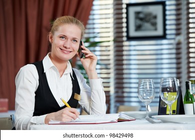 Happy Beautiful Restaurant Manager Woman Administrator At Work Place With Phone