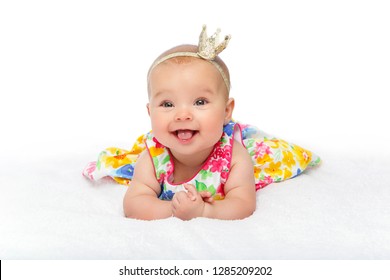 Happy Beautiful Toddler Baby Girl In Dress With Crown On Head. Studio Shot On White Backgound. Copy Space.