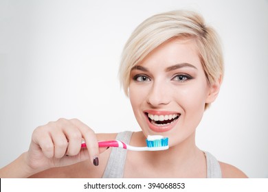 Happy Beautiful Woman Brushing Teeth Isolated On A White Background