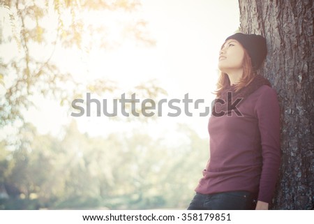 Similar – Image, Stock Photo Woman leans against a wall and puts her feet up.