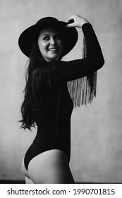 Happy And Beautiful Woman With Long Dark Hair In A Black Bodysuit And Hat. Country Style. Sexy Underwear And Clothes For The Theme Party.