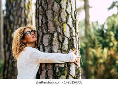 Happy Beautiful Woman Love Nature Hugging A Pine Tree - No Deforestation Concept And Earth's Day Celebration - Save Our Planet For A Nice And Better Future - Outdoor Leisure Activity For Nice People