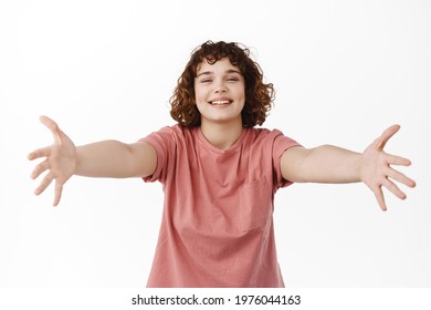 Happy Beautiful Woman Spread Hands Sideways And Smiling, Hugging Someone, Reaching For Embrace And Cuddles, Welcome And Greet Friend, Standing Against White Background