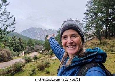 A happy beautiful woman taking a selfie portrait with smartphone on mountain at winter. - Powered by Shutterstock