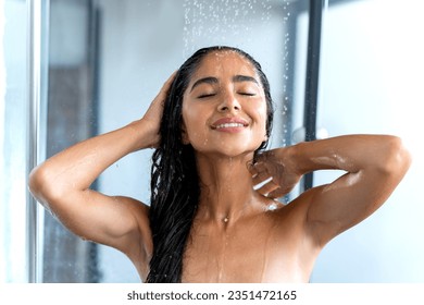 Happy beautiful woman taking shower and washing hair. Morning refreshment, healthy lifestyle. - Powered by Shutterstock