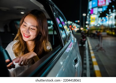 Happy Beautiful Woman Texting Smartphone Sitting Car Back Seat In Urban, Asian Businesswoman Working Late Commuting From Office In Taxi Backseat With Mobile Phone In City At Night After Late Work