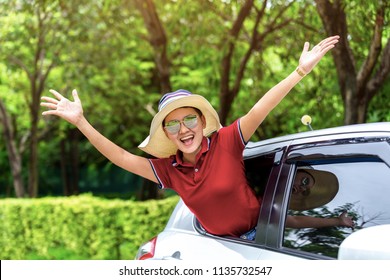 Happy beautiful woman traveling by a car relax in the holiday summer with nature, rural forest in the background.