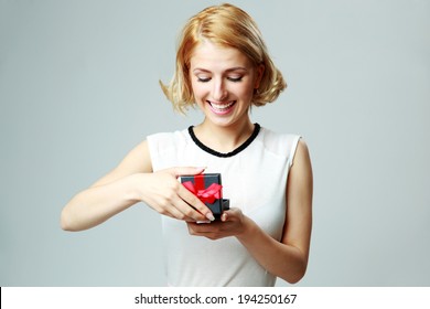 Happy Beautiful Young Woman Opening Jewelery Gift Box