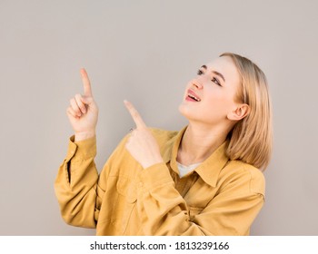 Happy Beautiful Young Woman Showing Way With Fingers