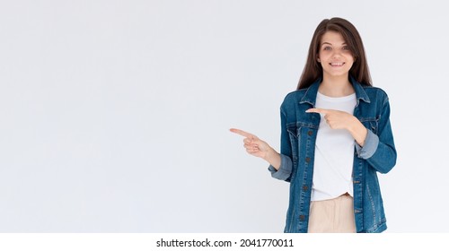 Happy Beautiful Young Woman Showing Way With Fingers