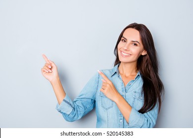 Happy beautiful young woman showing way with fingers