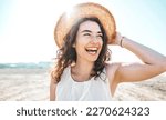 Happy beautiful young woman smiling at the beach side - Delightful girl enjoying sunny day out - Healthy lifestyle concept with female laughing outside 