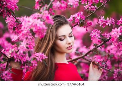 Happy Beautiful Young Woman In Spring Blossom Park. 