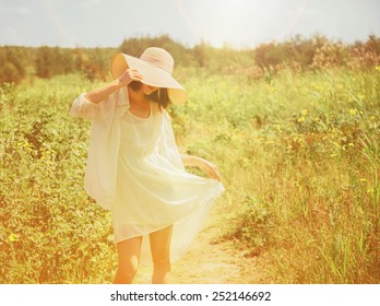 Happy Beautiful Young Woman Walking In Summer Park. Image With Sunlight Effect